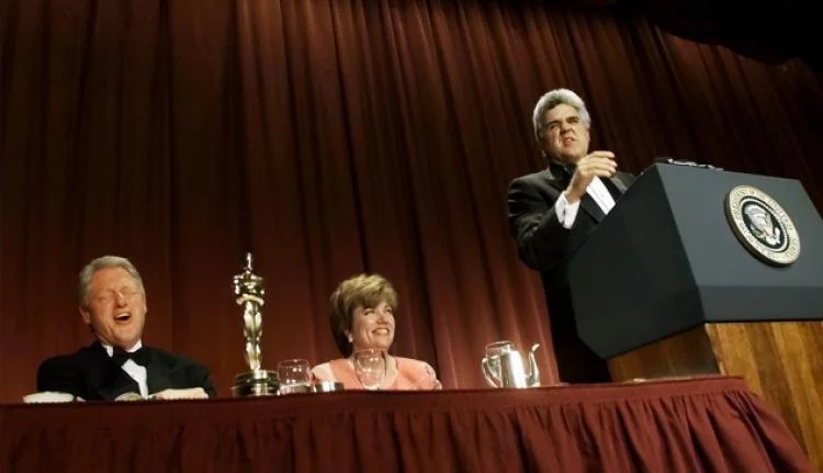 President Bill Clinton (left) laughs, as Jay Leno (right) tells a joke during the White House Correspondents' Association Dinner in 2000. Credit: New York Daily News