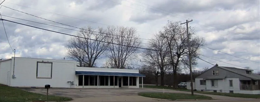 A view from SR 59 of the Campbell property; the storefront, left, and house on the right