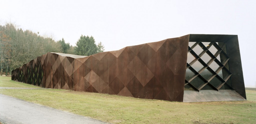From 2 to 7 metres (6 to 23 feet) high, stretching 43 metres long, this Memorial building lies on the ground like a wounded snake. Inside are recorded stories by and about some of the thousands of prisoners who lived and died here. 