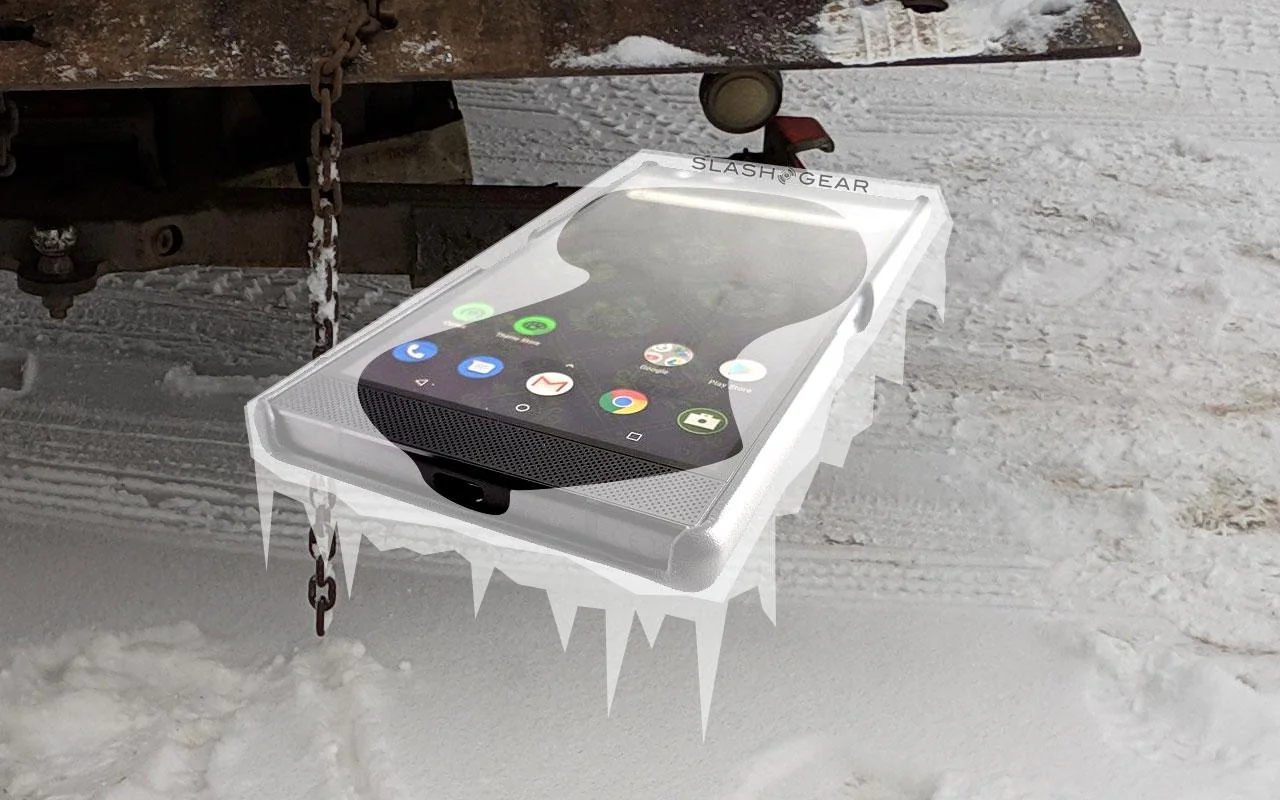 The subject of the article here was smartphone functionality in deep cold conditions. The Razer Phone here was photographed for a review, and was photographed on a white background to allow the end product to be used on any background. The ice is just two layers of semitransparent white clipped out and pasted over the phone. The background is a photo I’d taken earlier in the week of a tow truck that’d picked up my dysfunctional car.