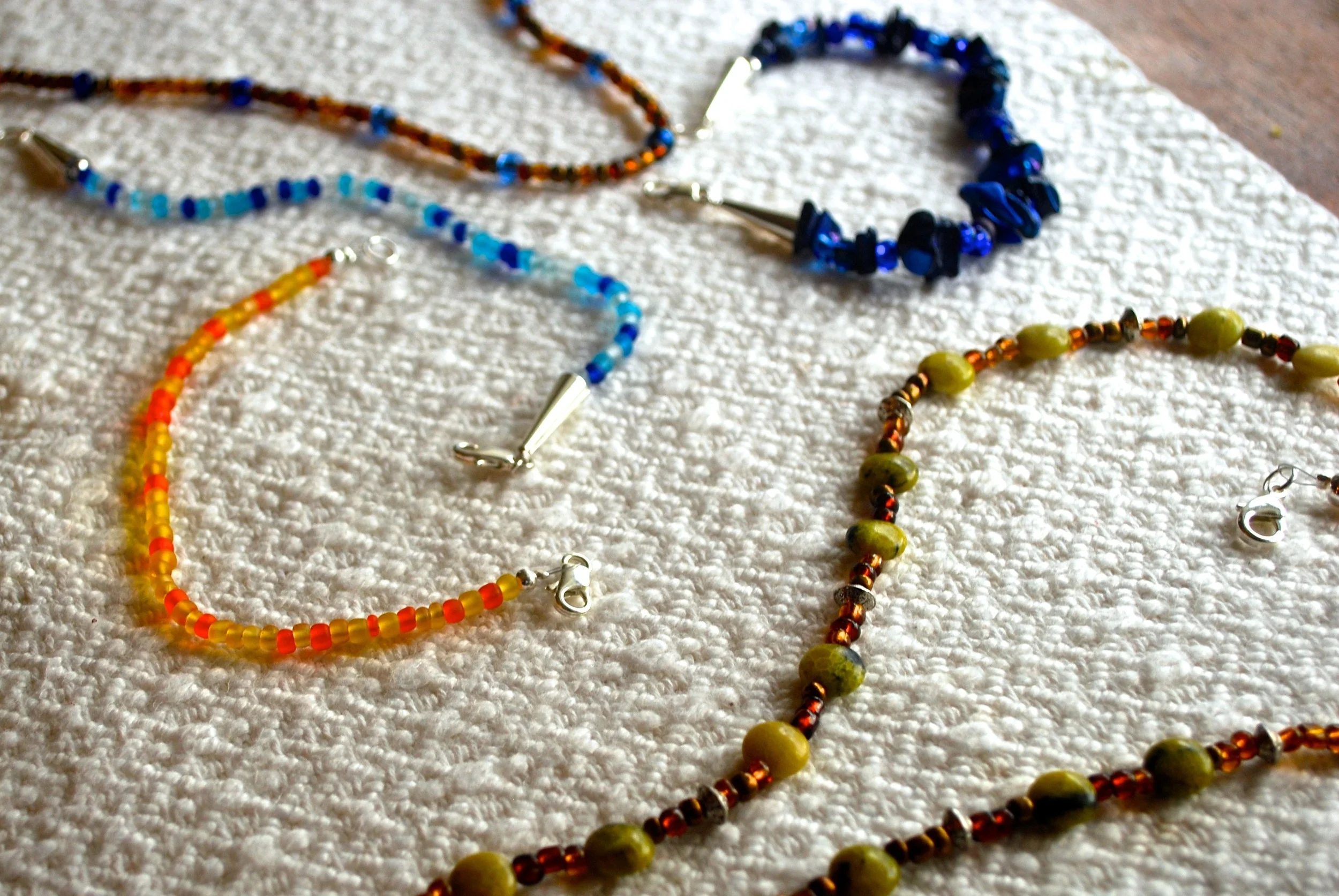 Various single strand necklaces and bracelets.