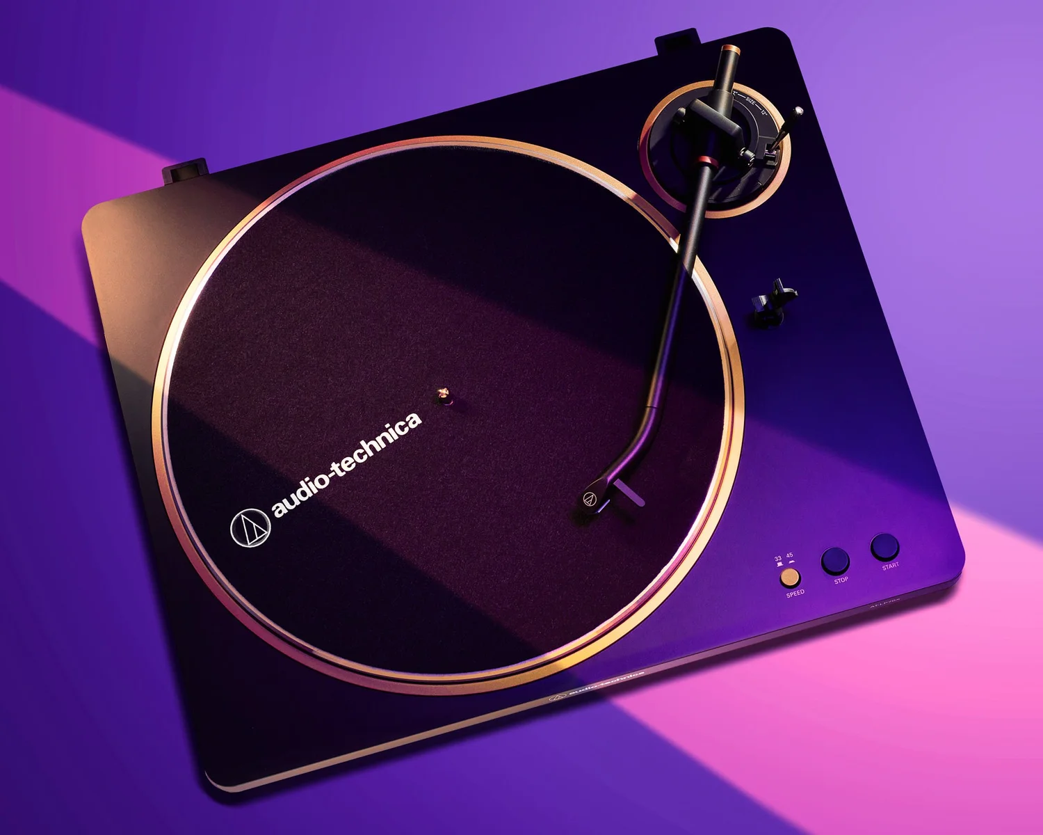 Styled commercial product photography of an Audio-Technica turntable on a vibrant colored background