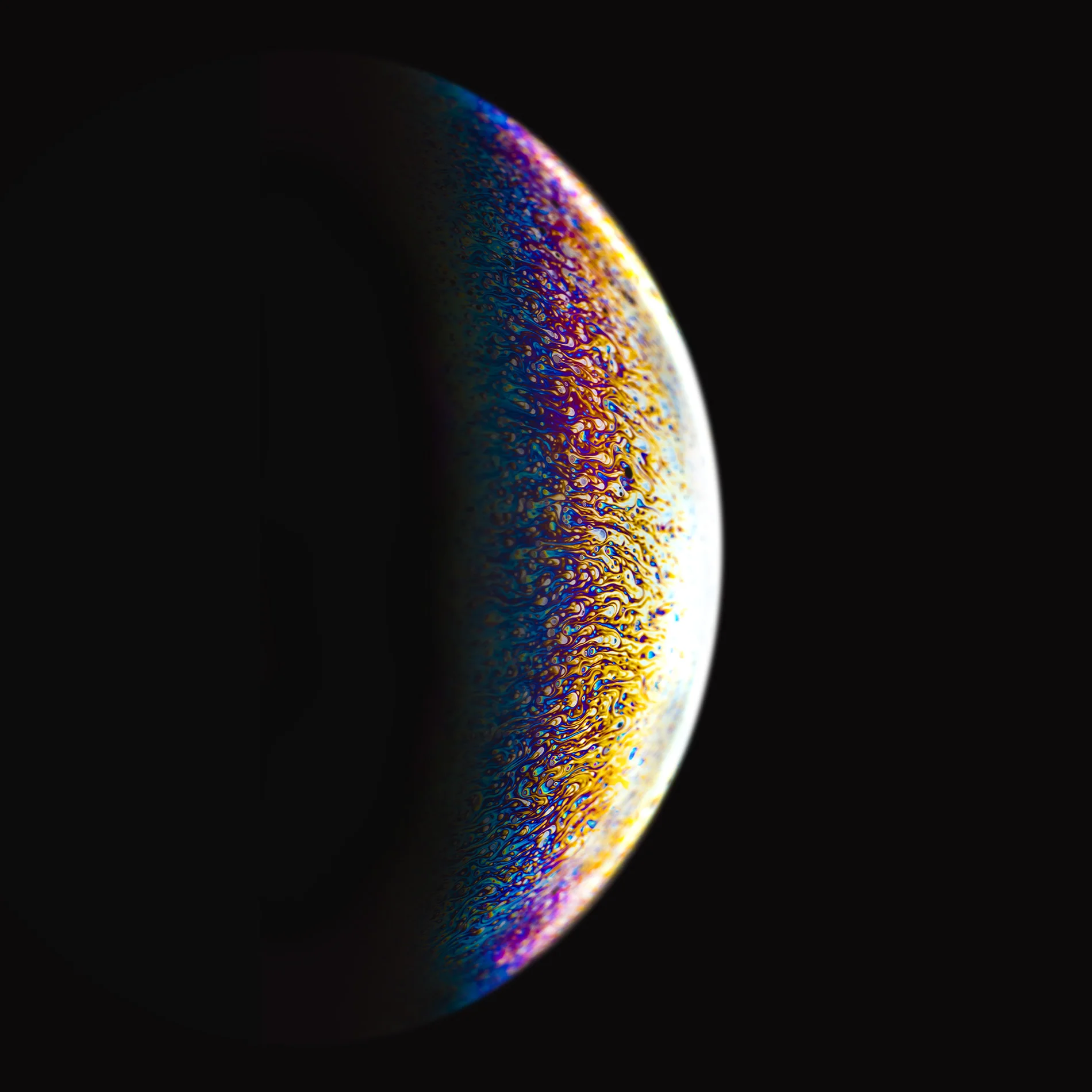  Soap bubbles illuminated by speedlights appear as small globes with surfaces of of infinitely complex&nbsp;colour and distorted liquid. 