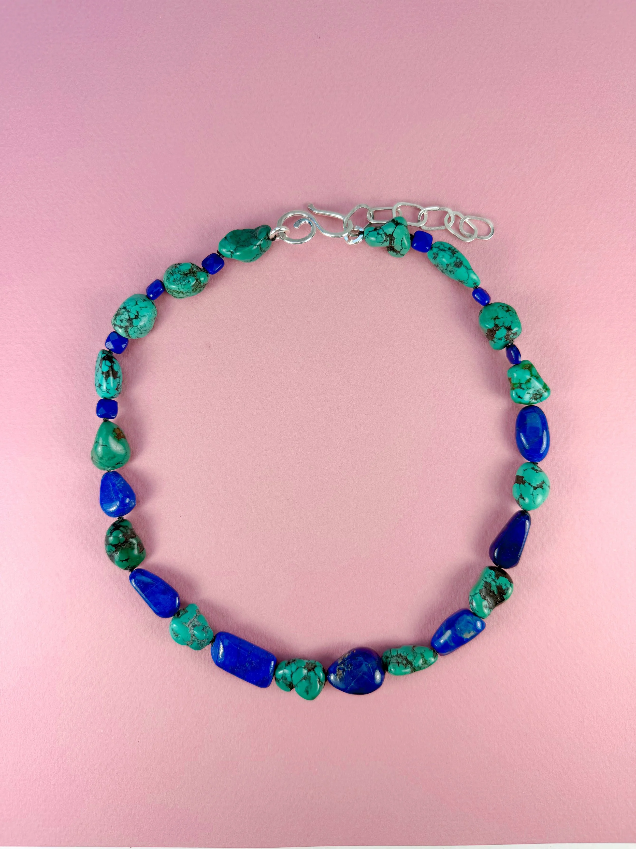 Turquoise and Lapis Stone Necklace on pink background