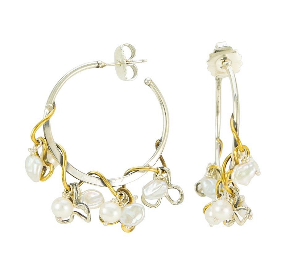 This feisty Floral Evo Hoop earring is the perfect antidote to all the gray days we&rsquo;ve had this spring. Bold metal details meet luminous freshwater pearls in a design that&rsquo;s guaranteed to lift your spirits&mdash;and your style. A little d