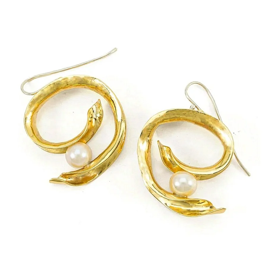 A fresh spin on our classic Gypsy Hoops, our Twisted Swirl Wire Earring is perfect for hoop lovers interested in a fresh silhouette. Handcrafted in Nashville, each pair features graceful anticlastic curves and freshwater pearls, delicately balanced o