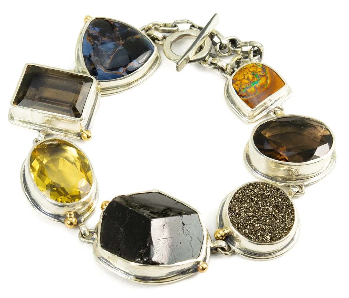 A true one-of-a-kind. Mixed natural stones - boulder opal, smoky quartz, druzy, black spinel, citrine and pietersite - in earthy blacks, warm browns, and golden yellows are hand - set in sterling silver and accented with 14k yellow gold balls. Finish