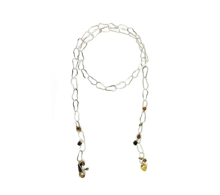 Hand-shaped links form a flowing lariat punctuated with fold and hollow form charms, accented by black spinel and brown freshwater pearls. Each element moves independently, catching light and shadow, creating a rhythm that feels alive. This versatile