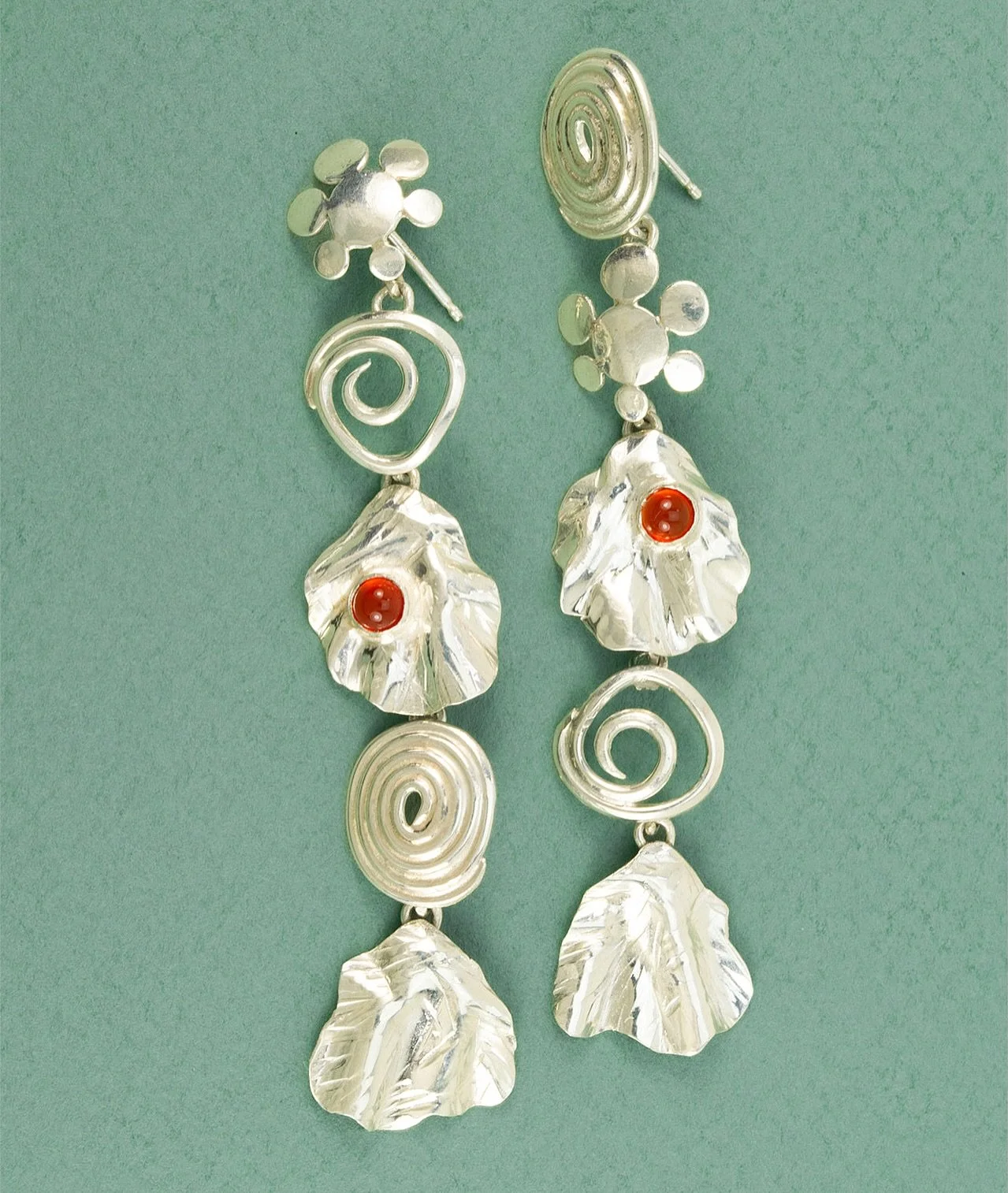 Collectible artisan jewelry, designed for everyday wear.

Mixed sterling silver elements and offset carnelian stones&mdash;each unique to the other, yet perfectly in sync.

Handmade in Nashville for the days you want to show the world who you are. 🔥