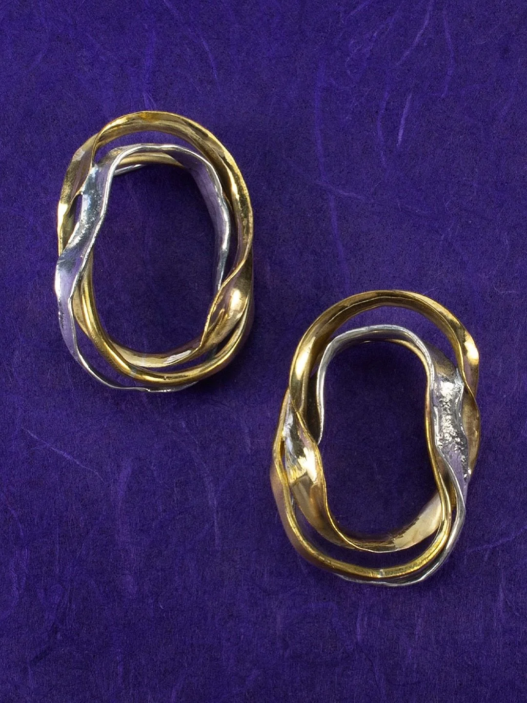 Forms literally melt into one another in this sculptural Evanescence hoop. Reticulated and anticlastic mixed-metal hoops intertwine, bringing together contrasting textures, unexpected shapes and movement.

Artful. Unconventional. Unmistakably ME.
