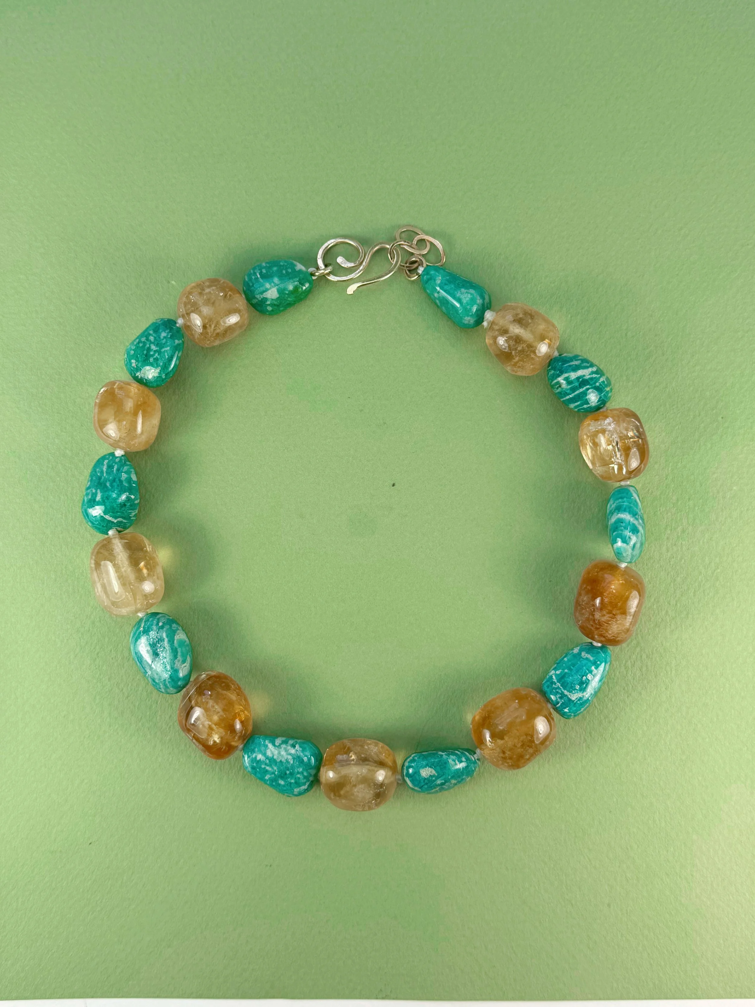 honey calcite and amazonite stone bead necklace on green background