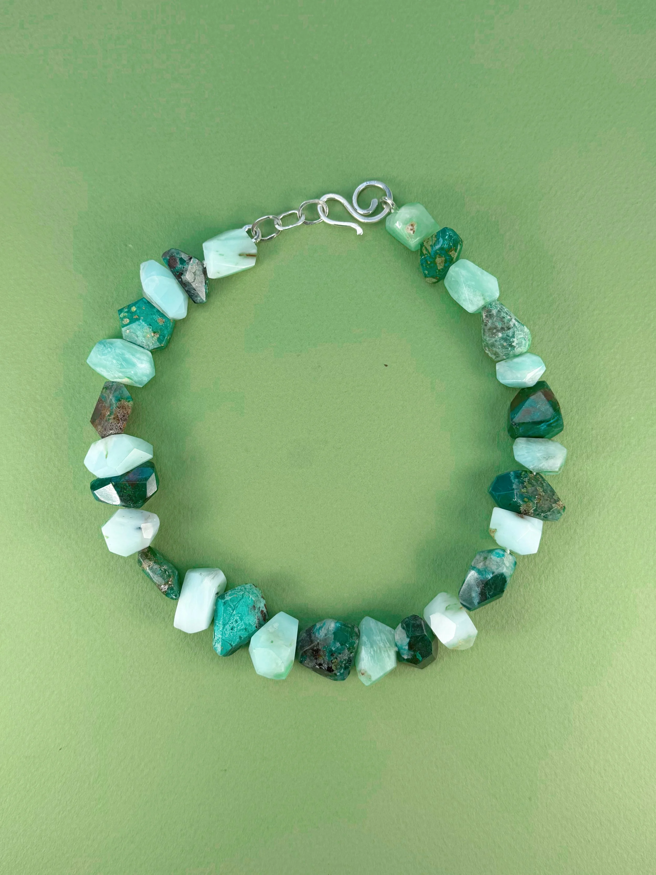 chrysoprase and chrysocolla stone bead necklace on green background