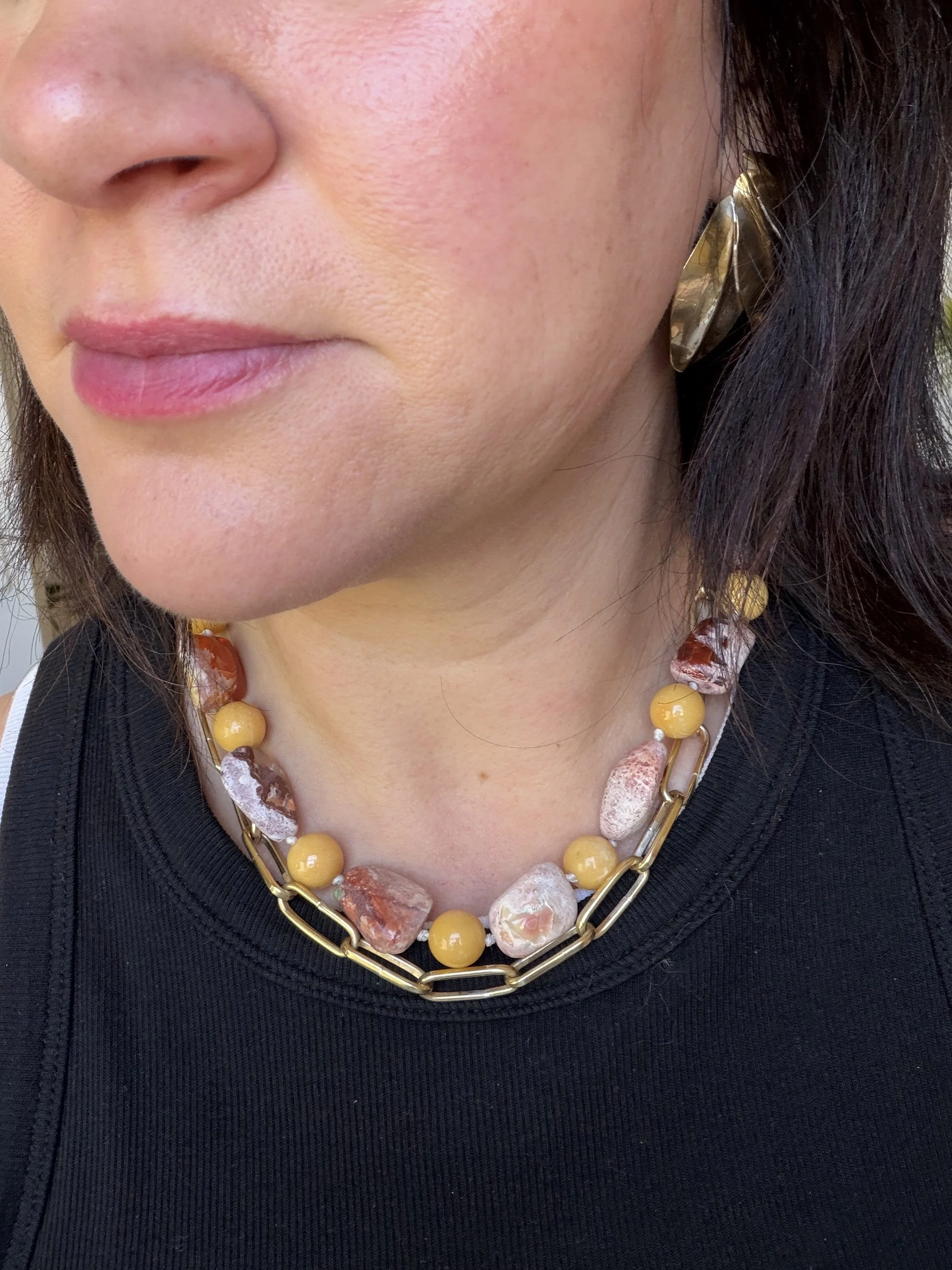 Mexican opals and yellow jade stone bead necklace worn on woman layered with gold chain