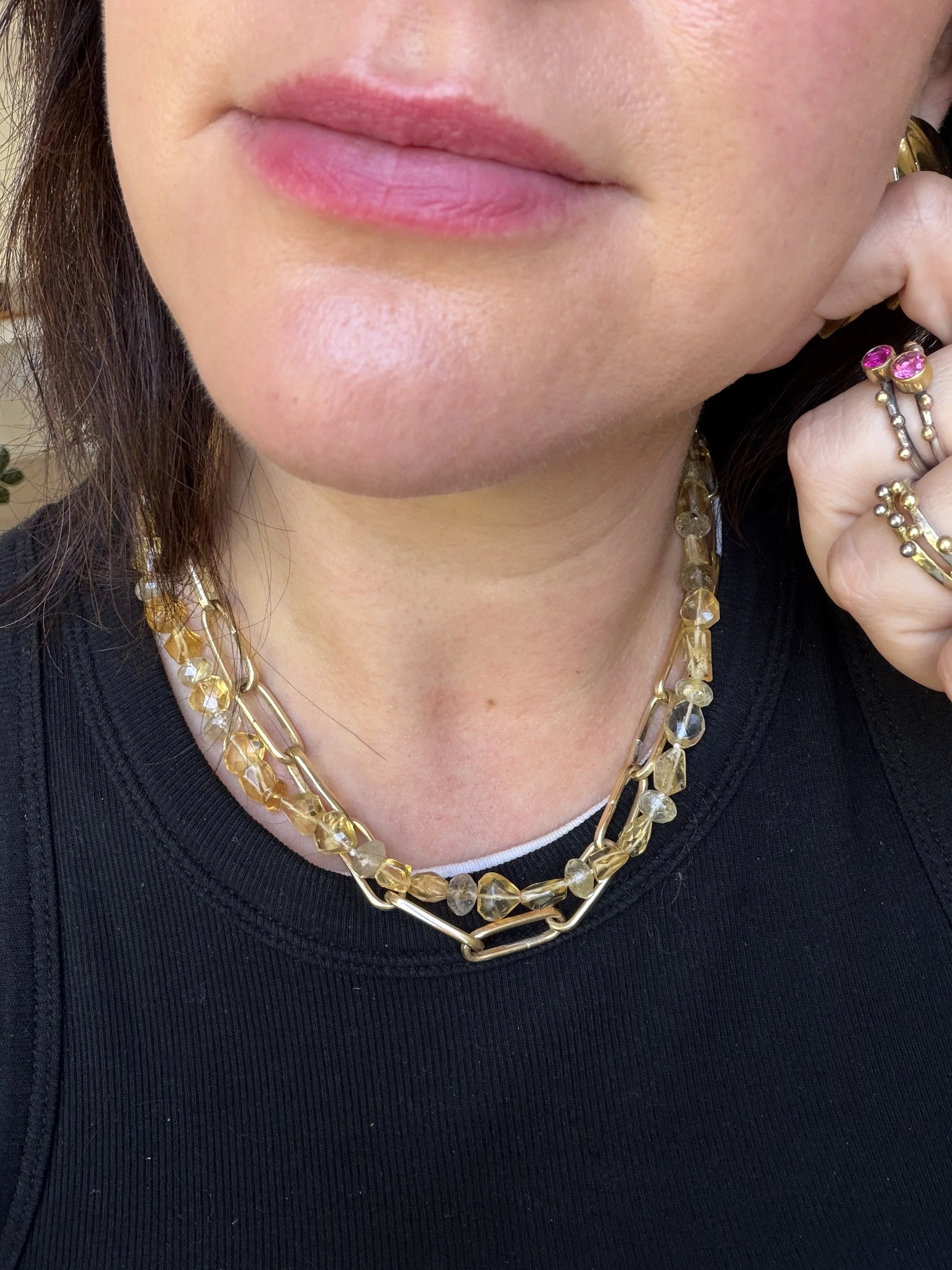 Citrine and rutilated quartz stone bead necklace worn on a woman