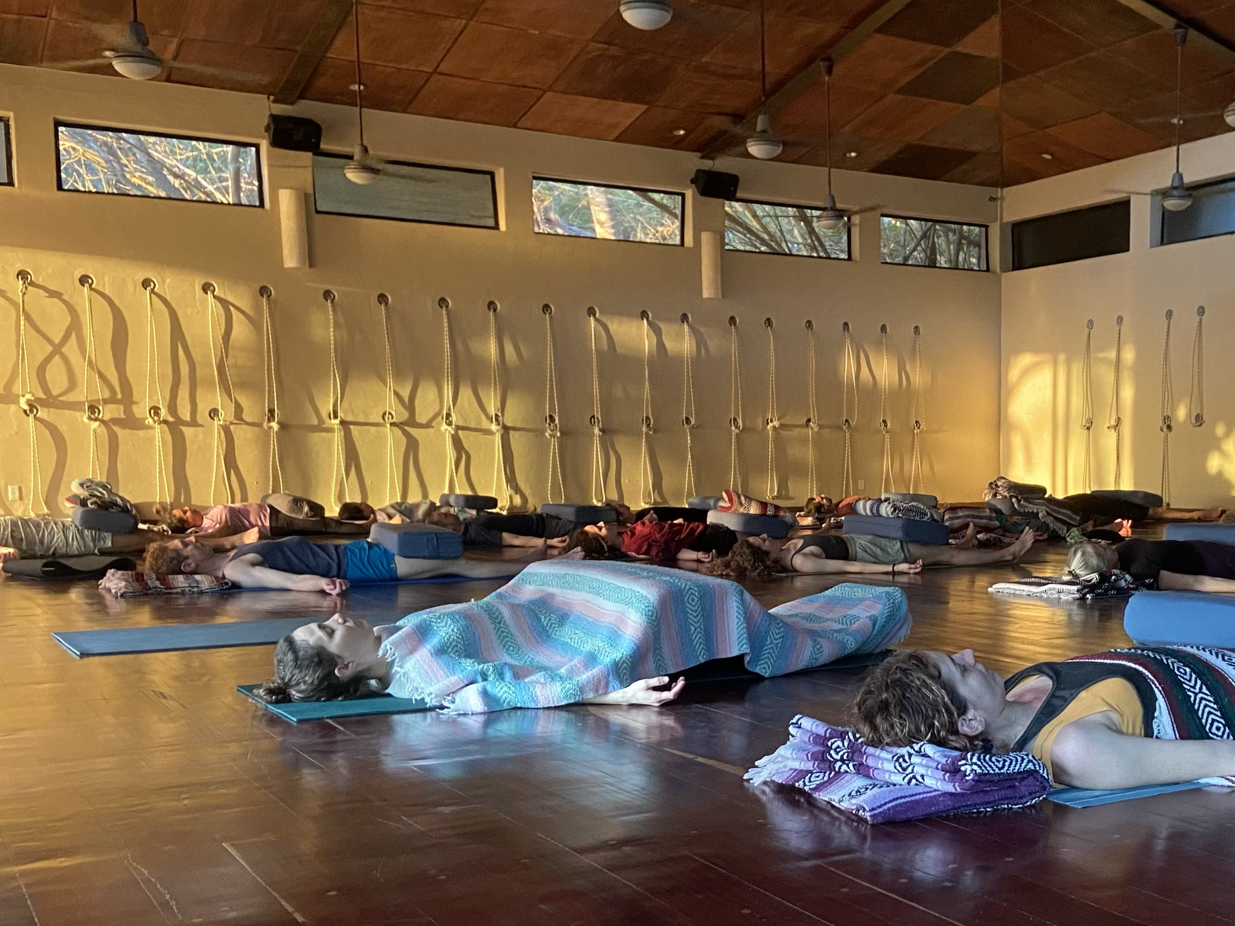 A yoga class taking savasana on Lara Warrens Mexico Yoga retreat