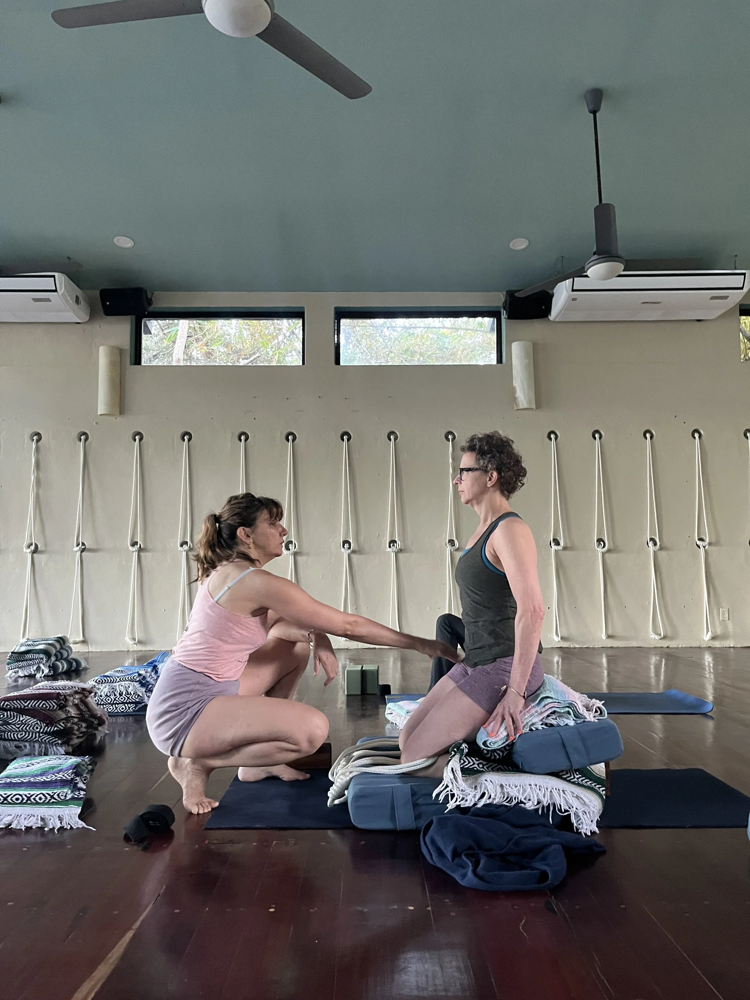 Senior Iyengar yoga teacher Lara Warren creating a therapeutic setup for Virasana Heros Pose.