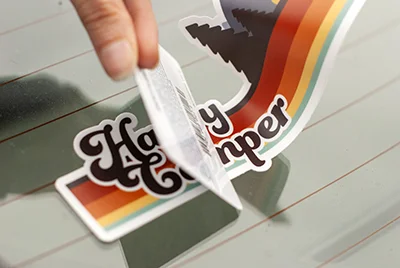 Use a card to remove air bubbles and wrinkles as you apply your vinyl sticker