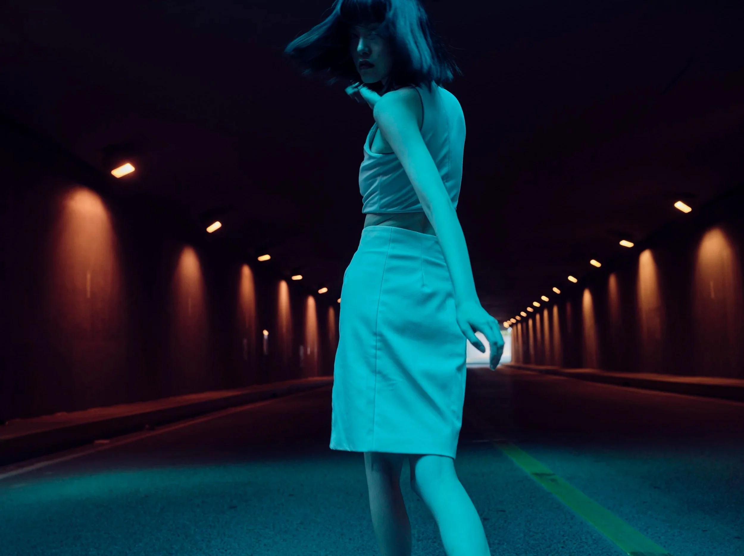 Woman in a light blue dress in a lit tunnel at night — Shanghai fashion and portrait photography | Victor Marvillet photographer