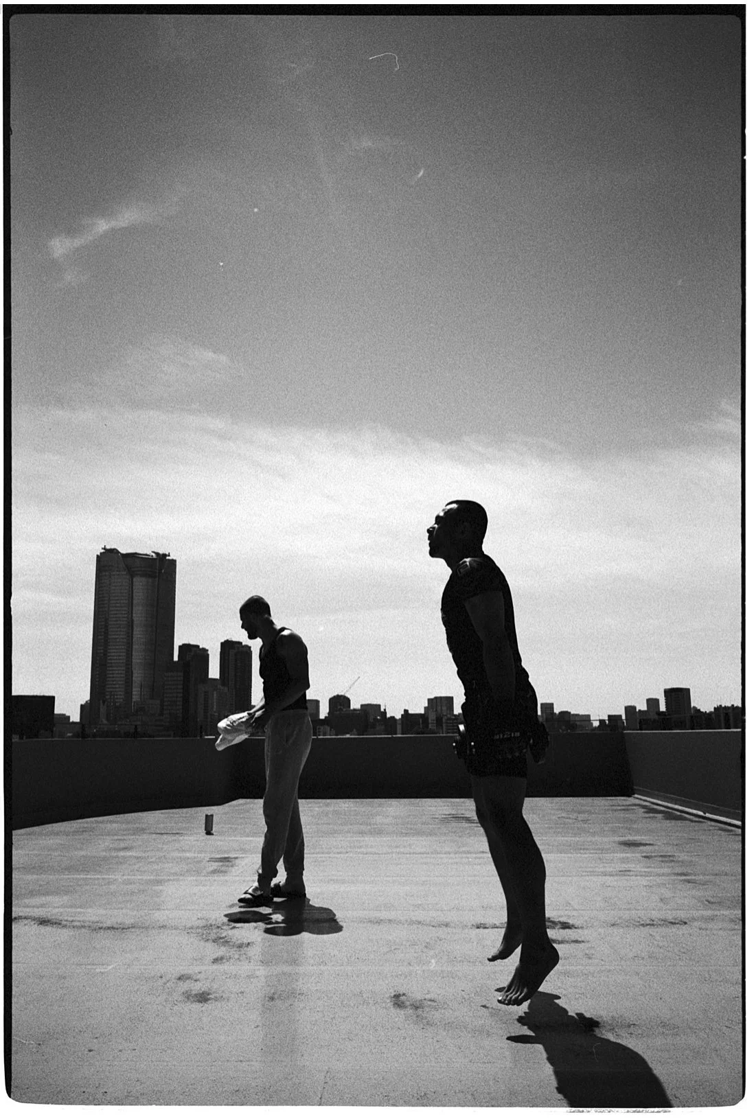 Black-and-white two fighters on a rooftop above the city — Shura No Hana MMA documentary, Tokyo | Victor Marvillet photographer