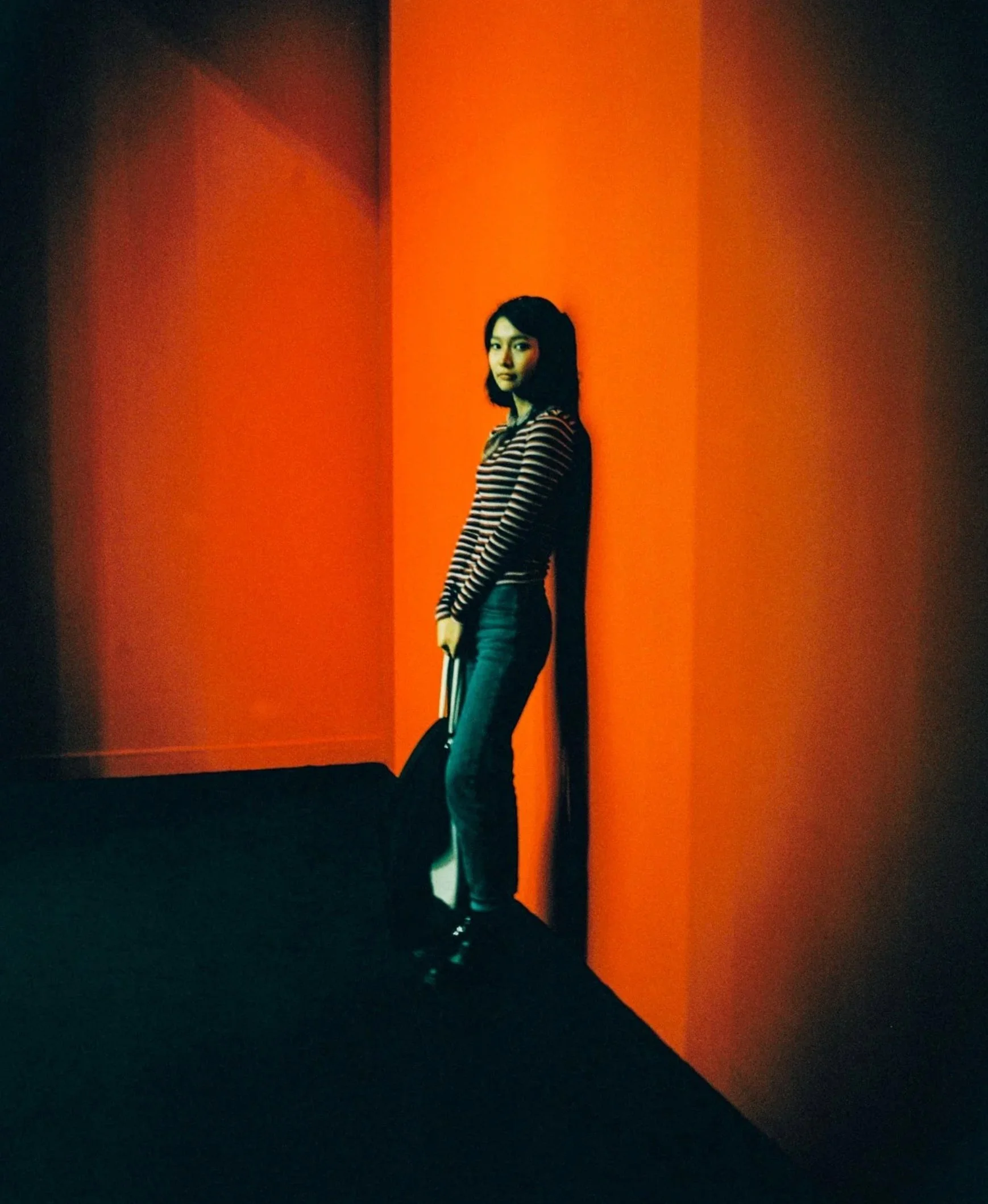 Woman standing in a corner of saturated orange light — Shanghai fashion and portrait photography | Victor Marvillet photographer