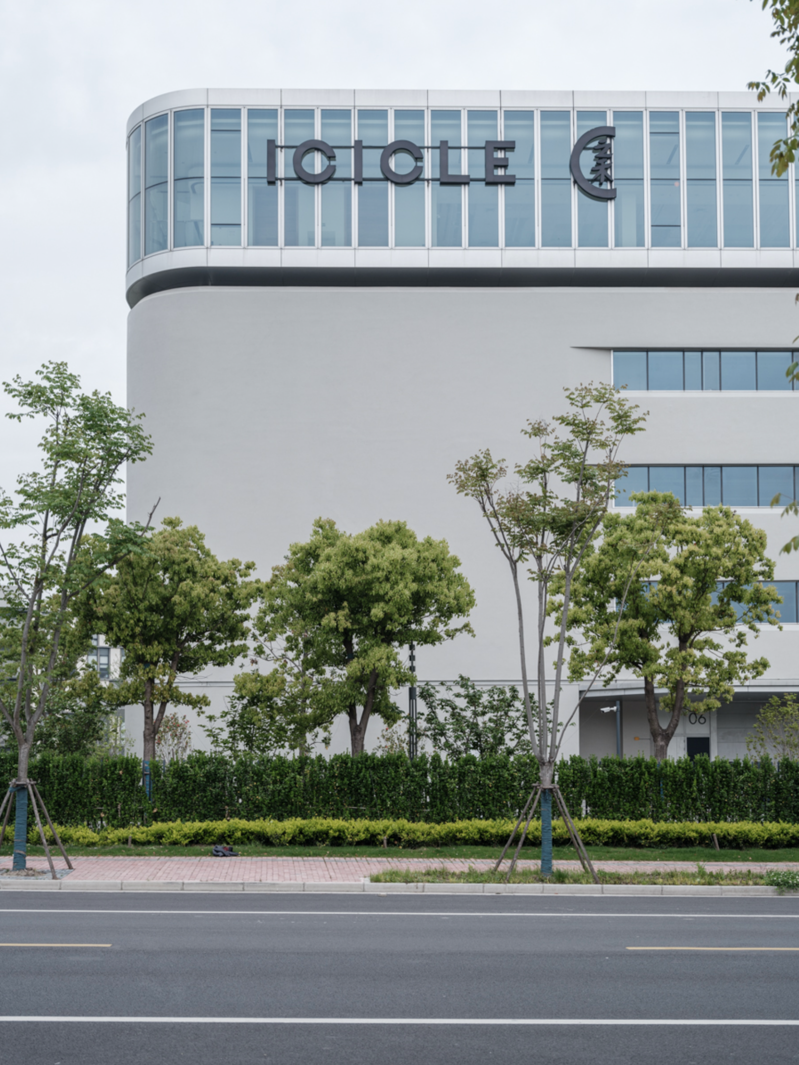 Exterior of Icicle Fashion Park building with brand signage and trees, Icicle campaign, China — Victor Marvillet photographer