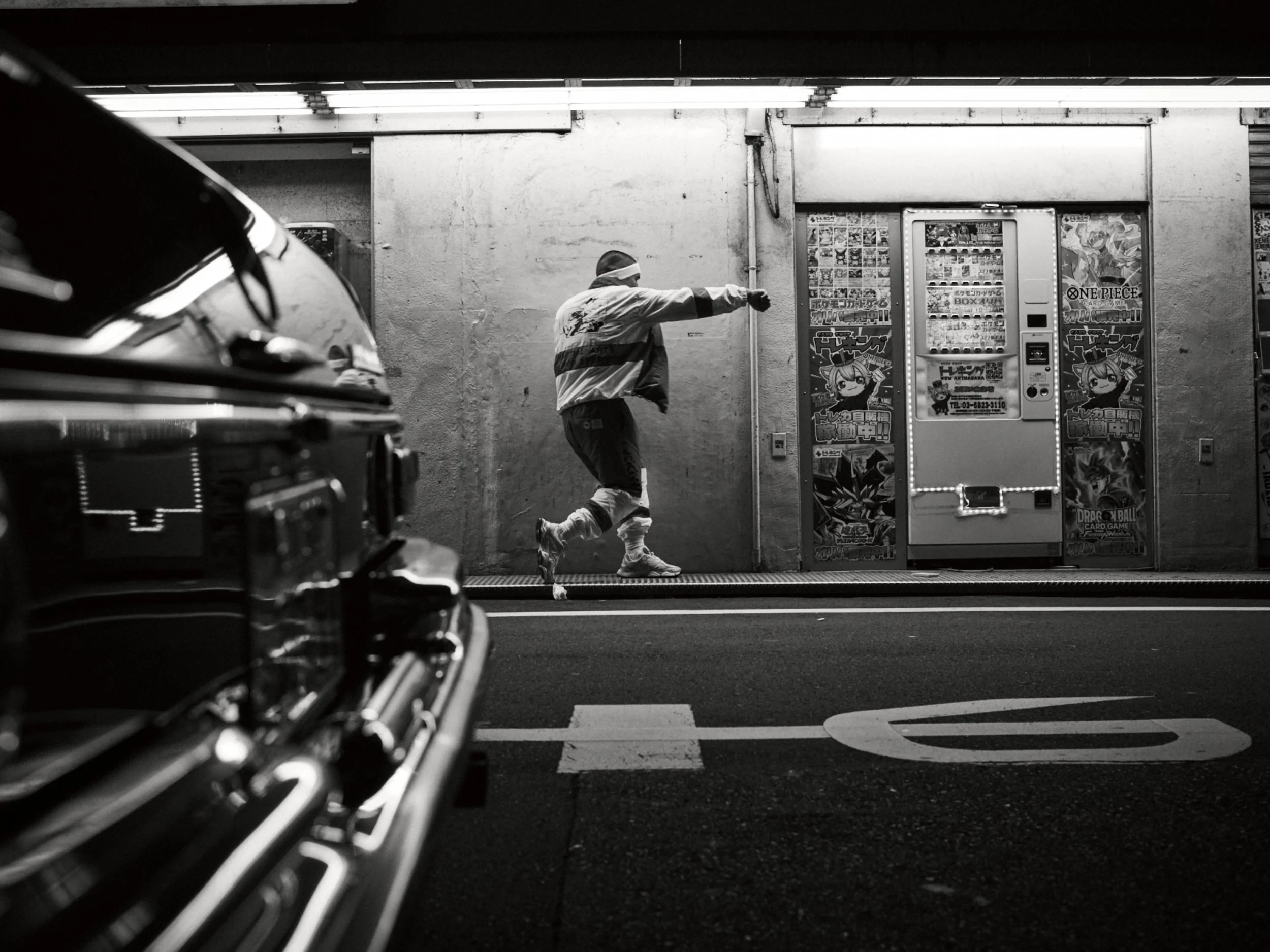 Black-and-white fighter shadowboxing in a parking garage — Shura No Hana MMA documentary, Tokyo | Victor Marvillet photographer