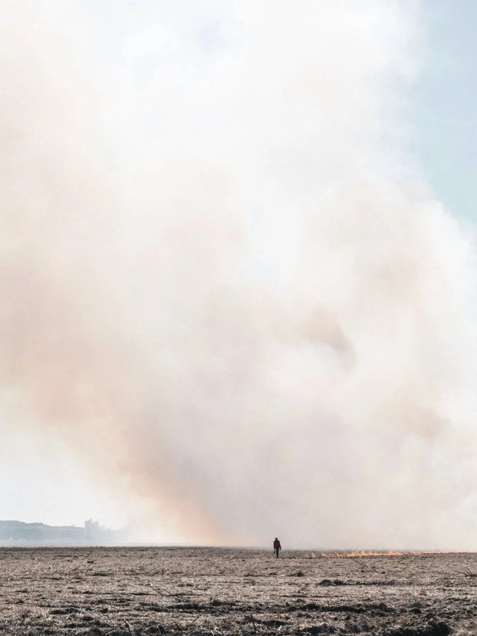 Hazy seascape with distant fire smoke on the water, Supernature personal documentary — Victor Marvillet photographer
