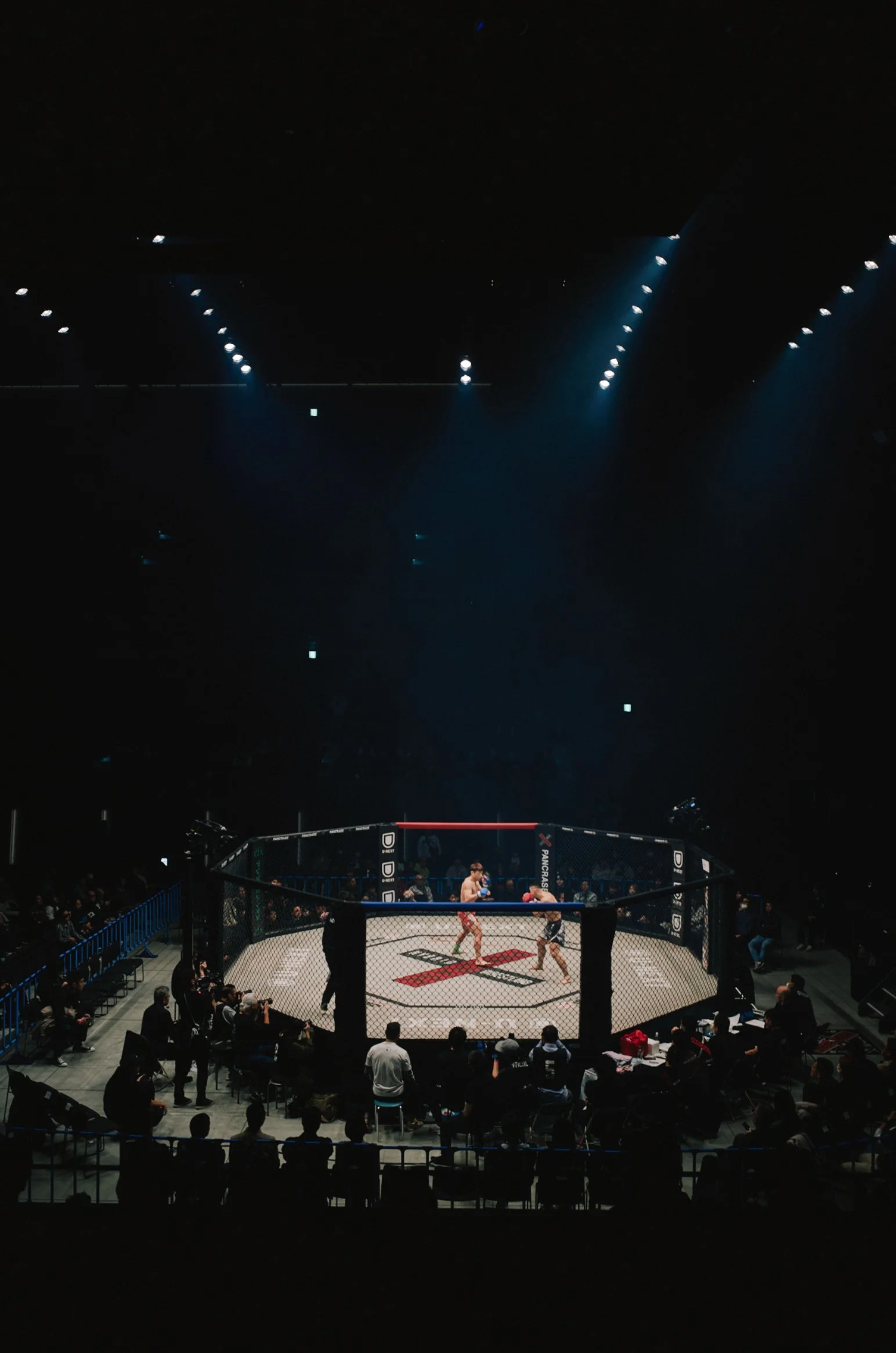 MMA cage under arena lights seen from above — Shura No Hana MMA documentary, Tokyo | Victor Marvillet photographer
