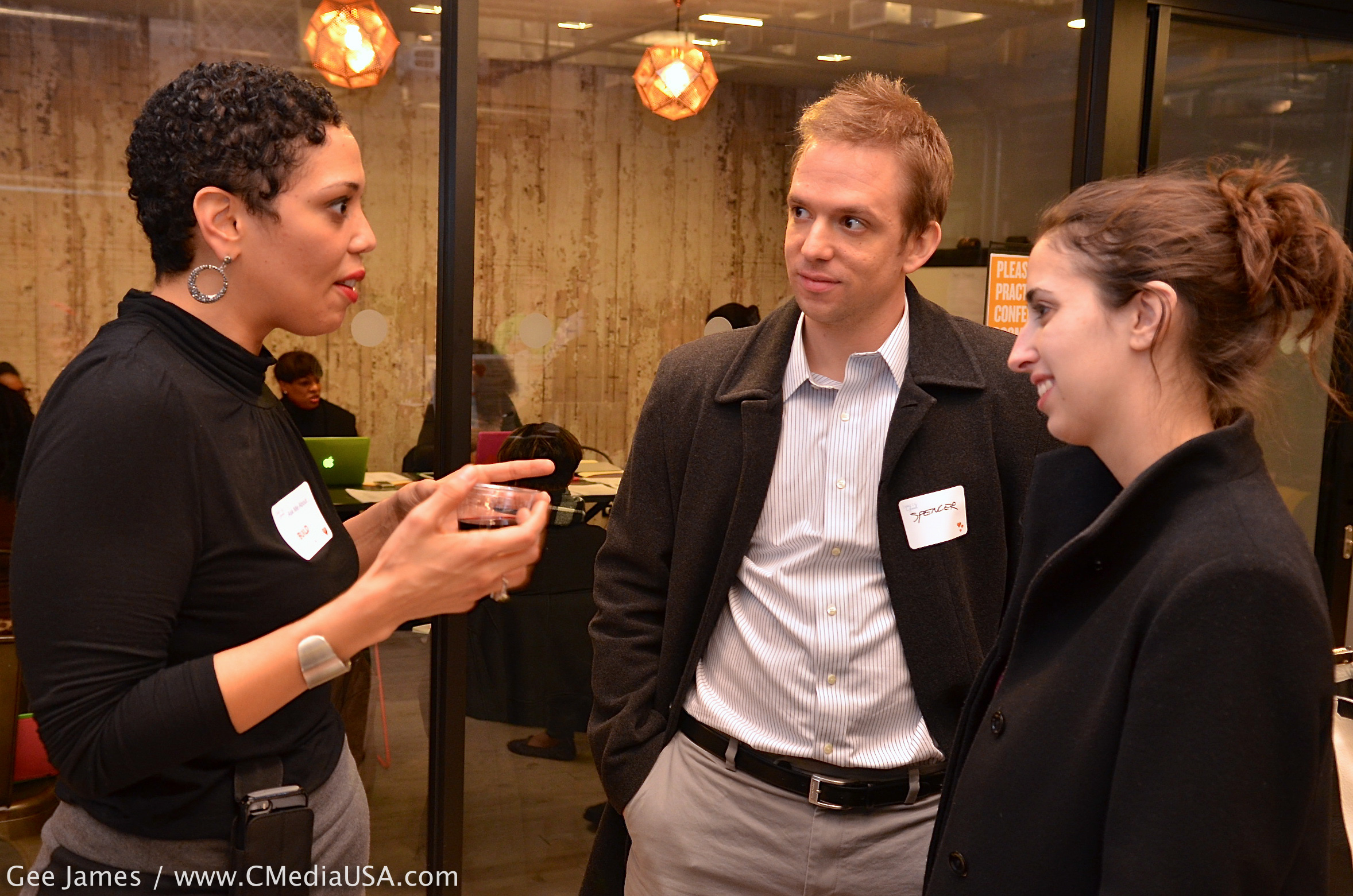  Natalie Benitez, program manager for BUILD, talks with Spencer Case and Rebecca Wolff. "We're looking to help make the world a better place," Spencer said./Photo by Gee James for CapitolMedia 