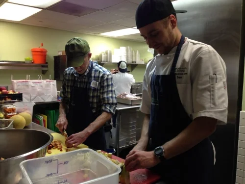 Volunteers help prepare dinner at Miriam's Kitchen