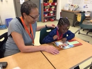 Alexis works with her student, Jada/Photo courtesy of Reading Partners