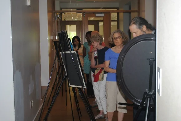Attendees view an art exhibit at Gandhi Brigade Youth Media Festival 