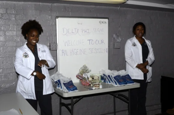 Stephanie Oboite and Sasha Bruce of The College of Dentistry at Howard University deliver a presentation on how to maintain good oral health./Photo courtesy of Young Ladies of Tomorrow