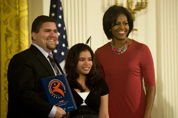 YPT student Mariana with then-CEO David Andrew Snider and First Lady Michelle Obama, 2010/Photo Source: Young Playwrights Theater