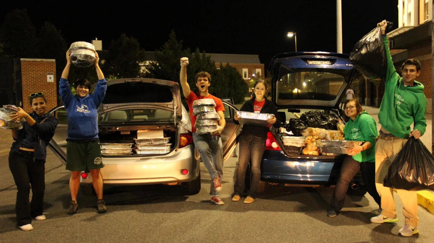 Students recover food after a football game/Photo credit: The Washington Post