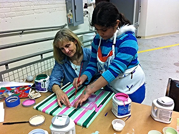 A SOHO mentor and student work together/ Photo source: Patch.com