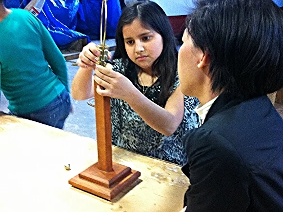 A SOHO student and mentor work on a lamp/ Photo source: Patch.com