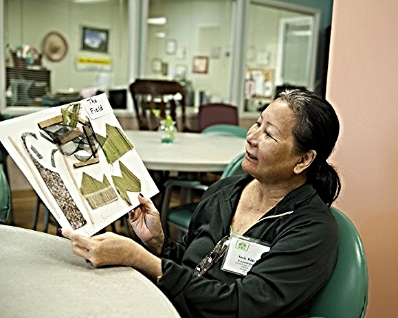 An artist admires her work at Alexandria Adult Day Services Center. (Photo Stephanie Williams)/Photo source: AFTA