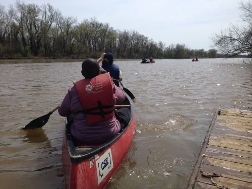 Piloting a two-person canoe requires both paddlers to communicate with, and depend on, each other. 