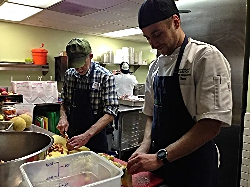Volunteers help prepare dinner at Miriam's Kitchen