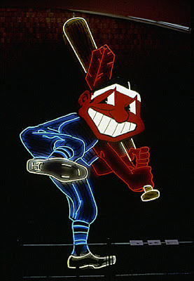 Chief Wahoo figure with neon tracing, once mounted atop Municipal Stadium, Cleveland. Stadium razed in 1996. Sign moved to the Western Reserve History Society in the University Circle district, on Cleveland's East Side. Contextualizing narrative presented on placard next to display. Figure approximately 15 feet tall.