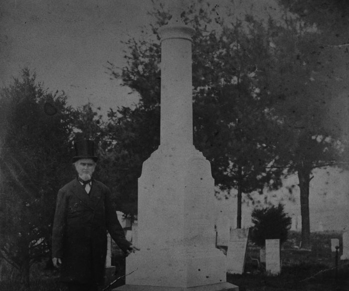 The top-hatted colonel standing next to his monument. He looks older. Seems likely to have been shot around 1880. 