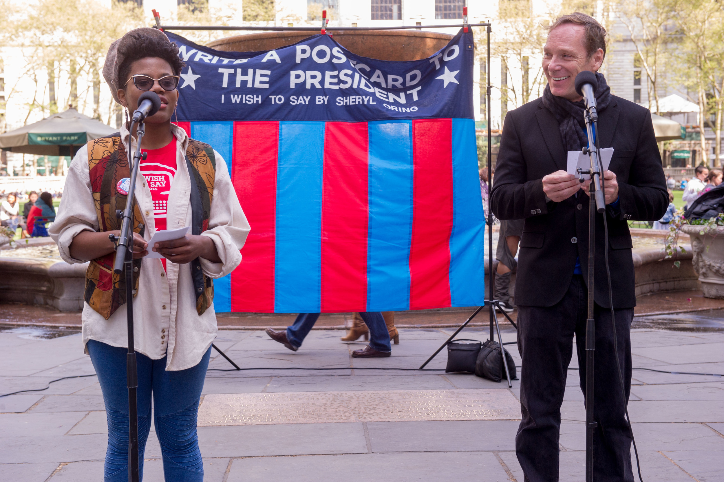  Madelynn Poulson and Hans Tester read messages to the presidential candidates dictated at Bryant Park. Photo by Christian Carter-Ross. 