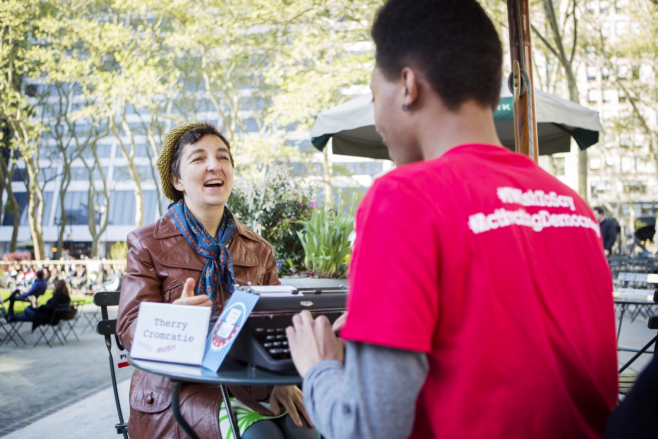  Liena Vayzman dictates a message to one of the candidates while UNCG student Therry Cromratie types it up. Photo by Jiyoung Park. 