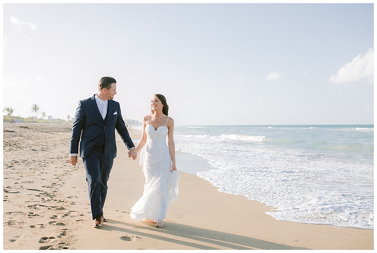 Bride and Groom walking on the beach at Hutchinson Shores Resort and Spa