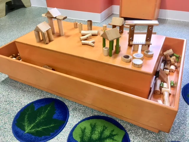 NATURE BLOCK TABLE Smooth logs, bamboo planks and dowels inspire building play with natural materials. Sponsored by Don Sesslar and Dawn Shonk.