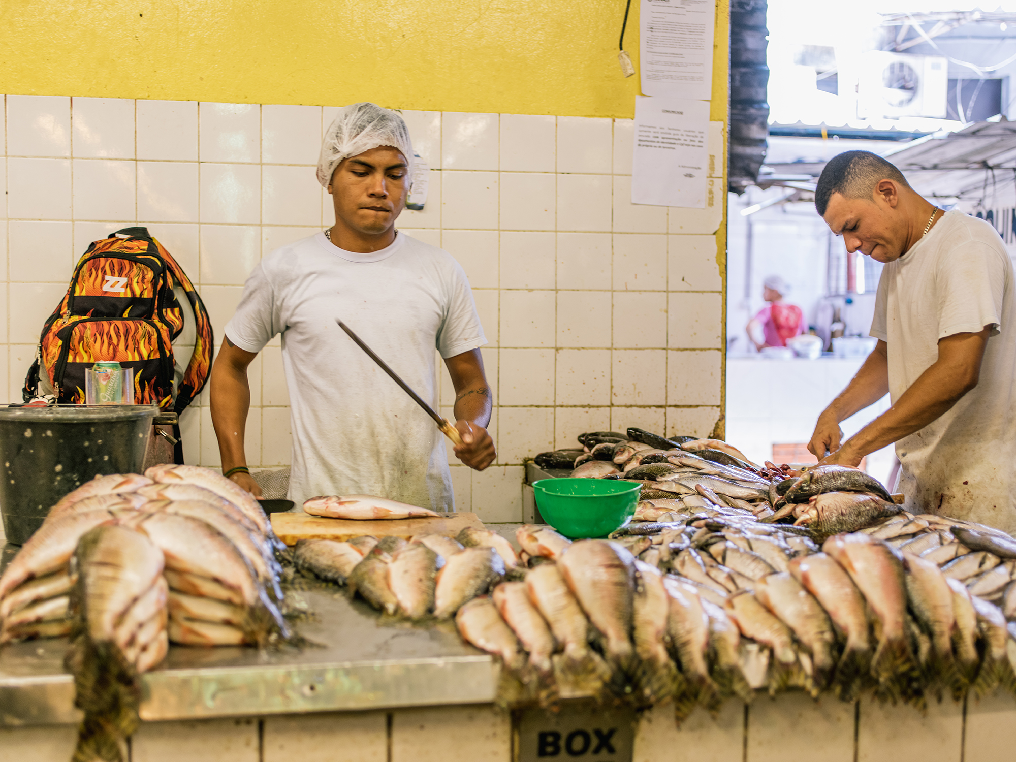 Workers constantly cleaning and setting out fish for sale.