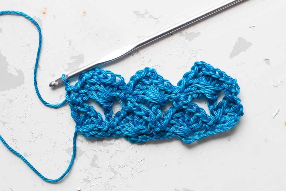 Step 5: Repeat steps 2-4 across the row, finishing with a dc into the last dc of the row below. Turn. 