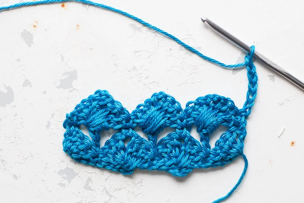 Row 3: Step 1: Chain 6 - this counts as 1 treble and 3 chains. 