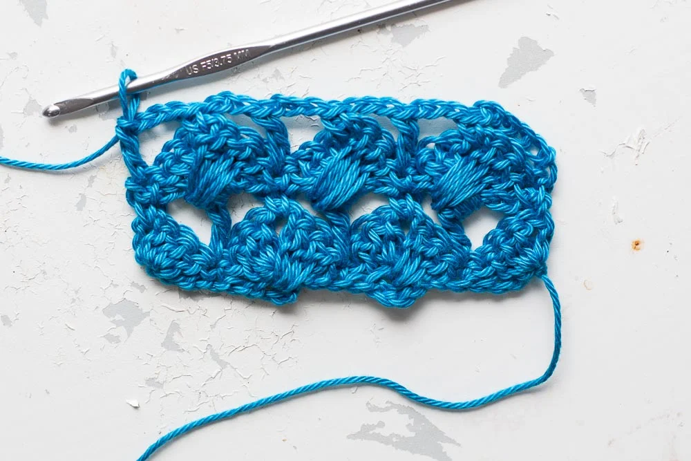 Step 4: Treble into the final dc of the row below. Turn.